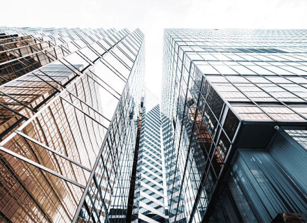 bottom view of two mirrored buildings, with the space of a street between them