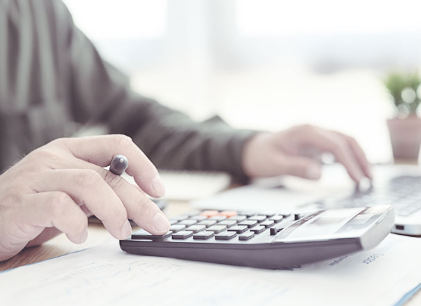 Person using black calculator with black and red keys